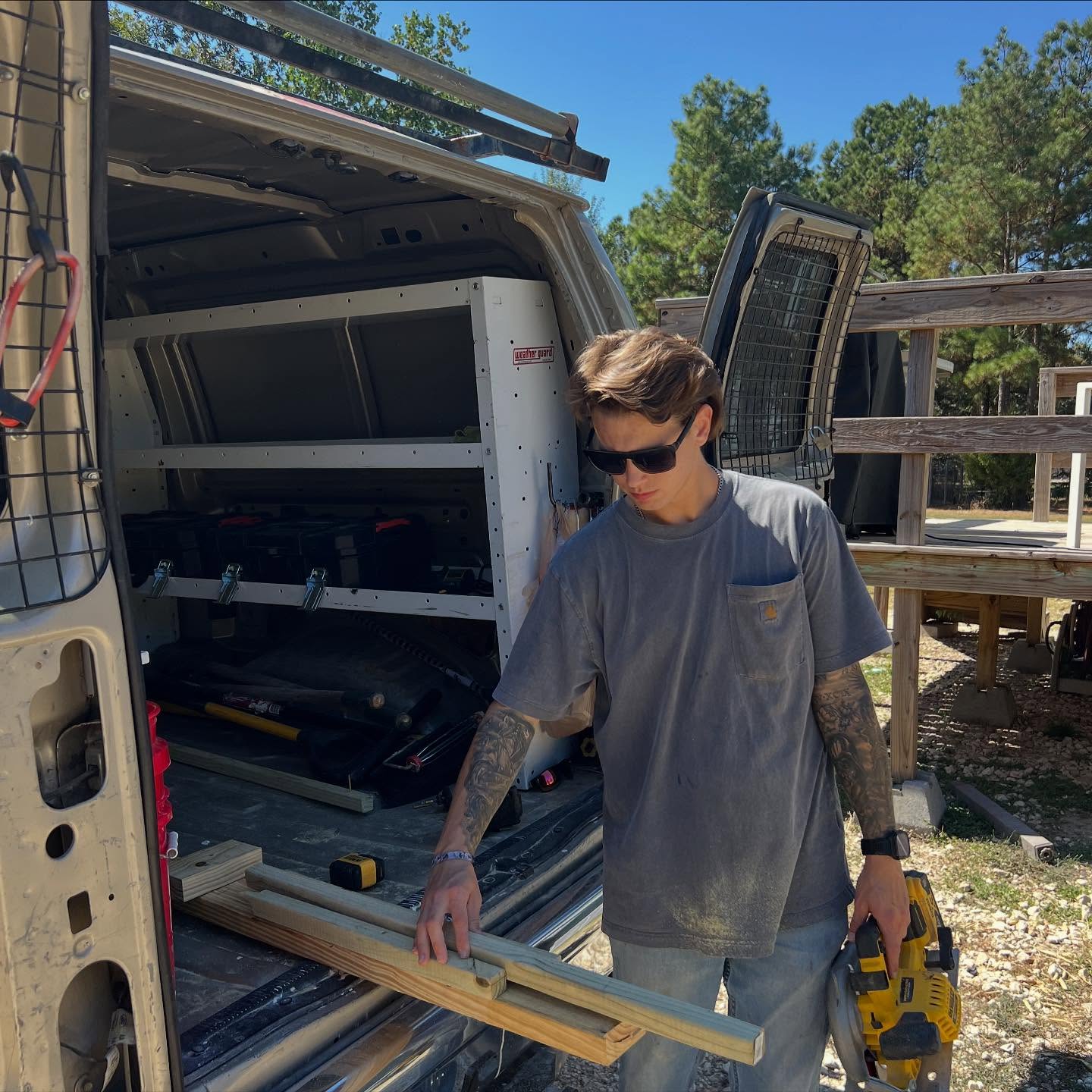 Nate, your Conroe handyman, loading lumber at his work van