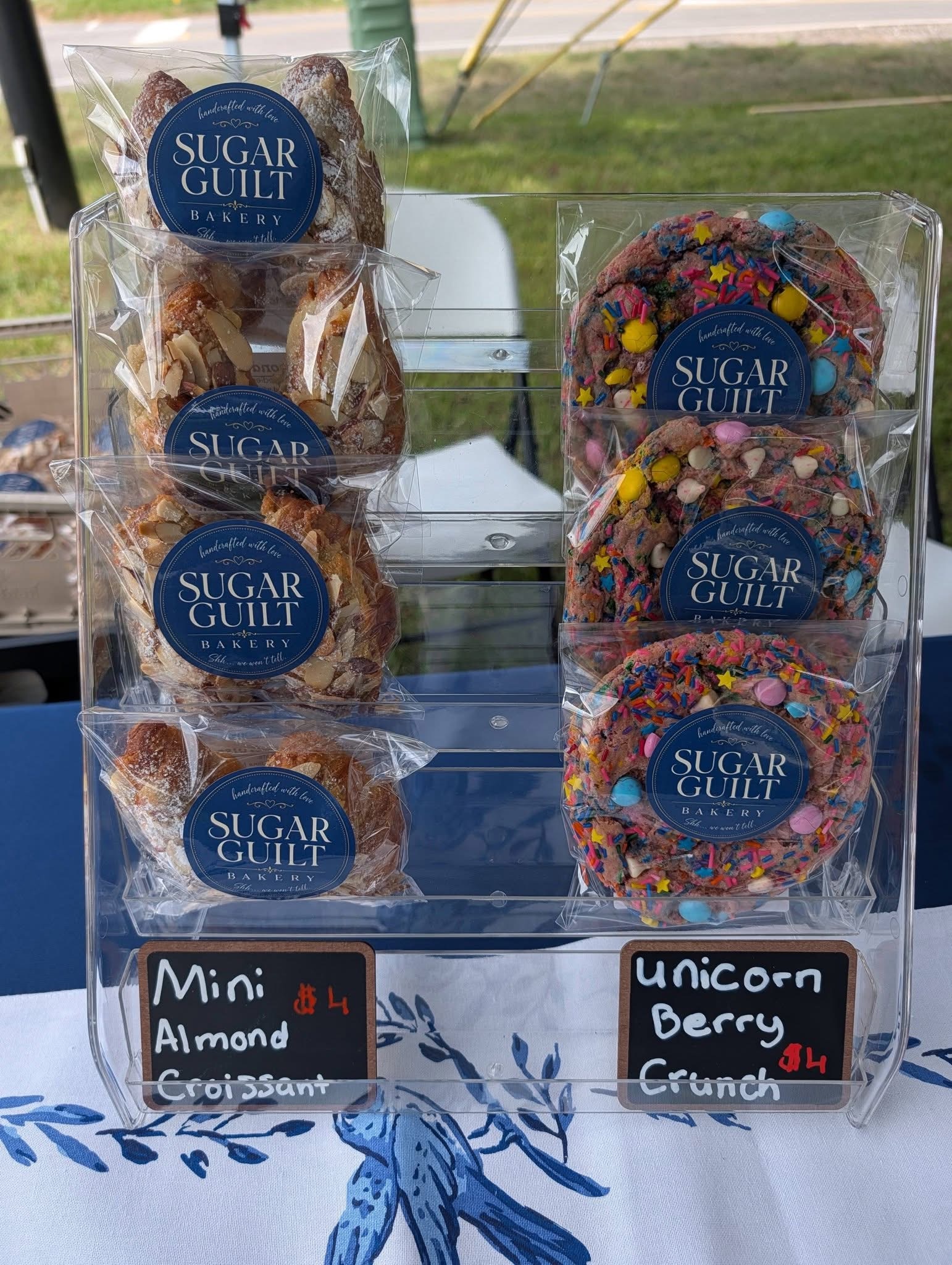 Mini almond croissants and unicorn berry crunch cookies on the market stand